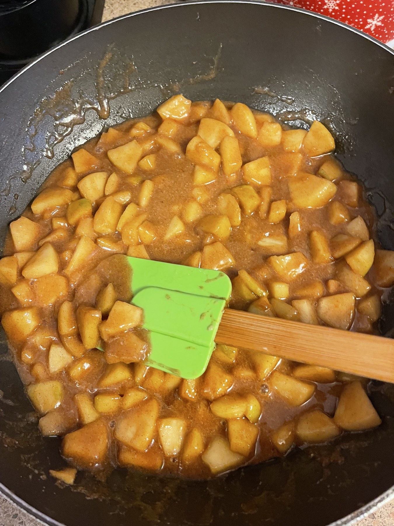 Diced apples cooking in glossy cinnamon apple pie goo