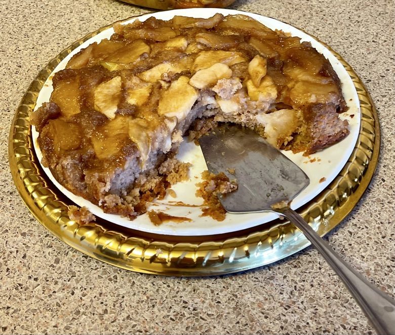 Caramel apple upside-down cake with a slice served