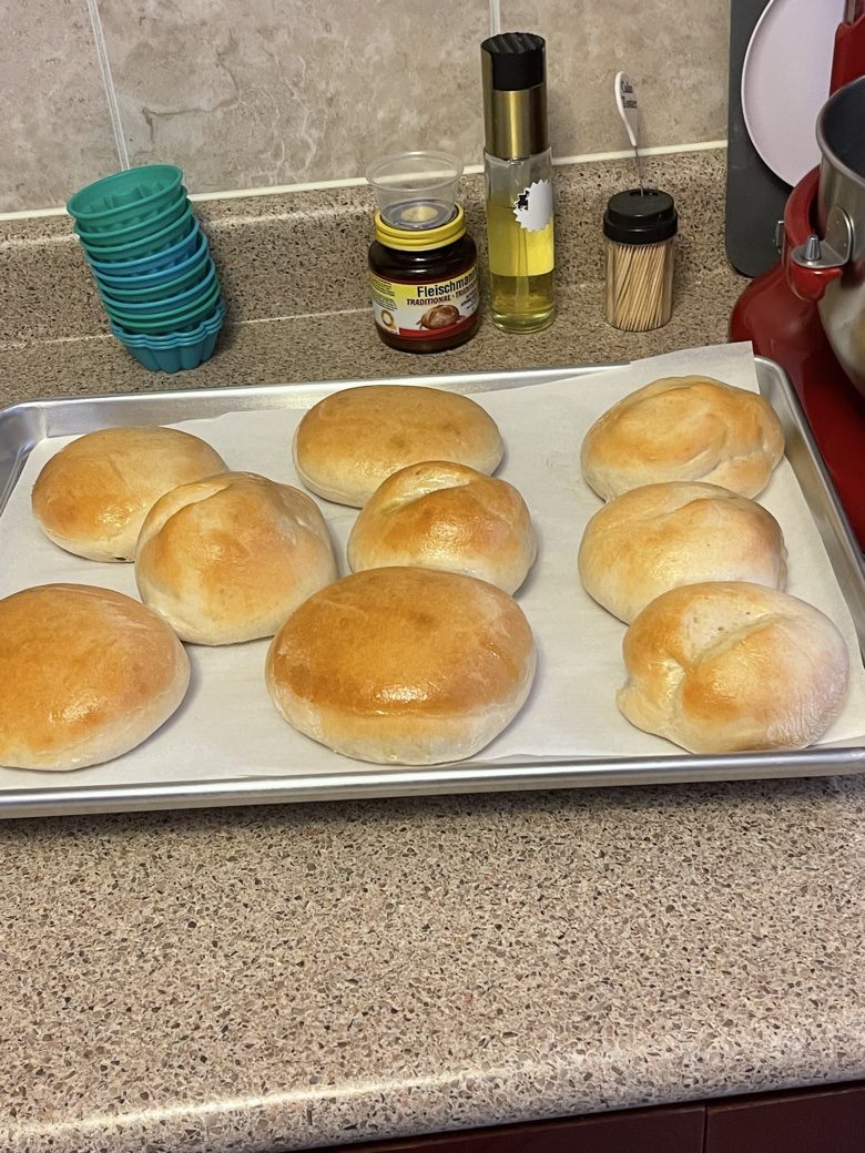 Fresh dinner rolls on a baking tray