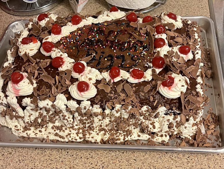 Chocolate sheet cake with cherries and chocolate shavings