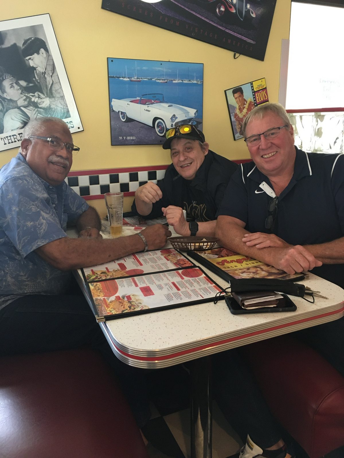Paul, Robert, and Bob smiling together over lunch